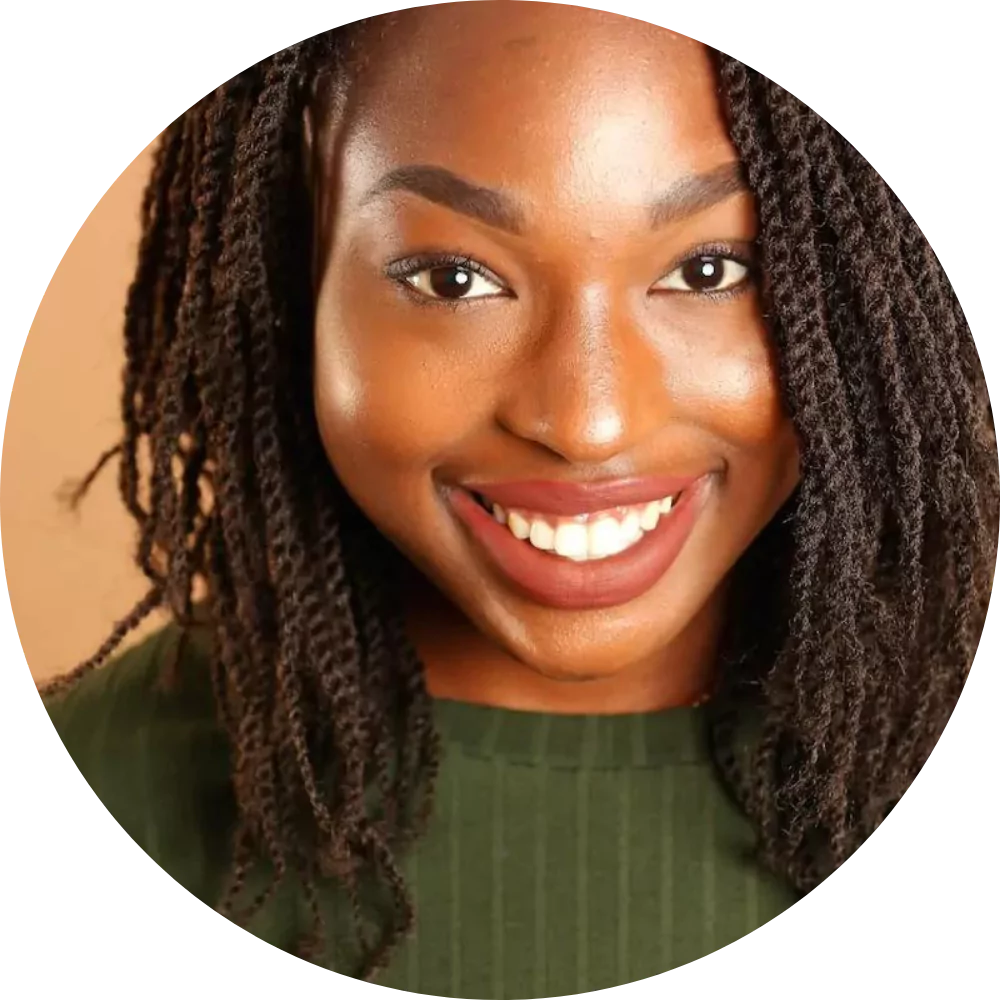 Smiling woman with braids and green top